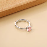 Smooth four prong band & round Pink diamond ring