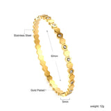 Hard bracelet with diamonds strung together with small gold-colored discs