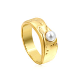 Gold-colored ring with a pearl surface