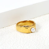 Gold-colored ring with a pearl surface