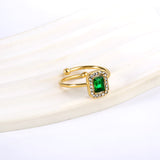 Baguette green diamond with small white diamonds ending in an open round bead ring