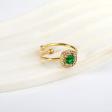 Square green diamond with small white diamonds ending in an open round bead ring