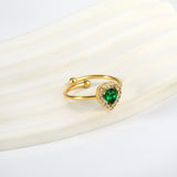 Heart shaped green diamond with small white diamonds ending in an open round bead ring