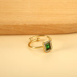 Baguette green diamond with small white diamonds ending in an open round bead ring