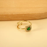 Square green diamond with small white diamonds ending in an open round bead ring