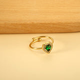 Heart shaped green diamond with small white diamonds ending in an open round bead ring