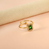 Baguette green diamond with small white diamonds ending in an open round bead ring