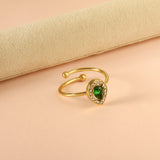 Teardrop green diamond with small white diamonds ending in an open round bead ring