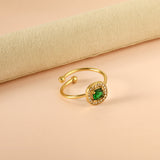 Square green diamond with small white diamonds ending in an open round bead ring