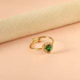 Heart shaped green diamond with small white diamonds ending in an open round bead ring