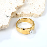 Gold-colored ring with a pearl surface