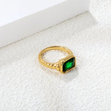 Oversized green diamonds on a threaded band ring.