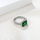 Oversized green diamonds on a threaded band ring.