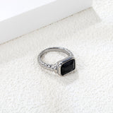 Oversized black diamonds on a threaded band ring.