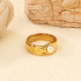 Gold-colored ring with a pearl surface