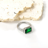 Oversized green diamonds on a threaded band ring.