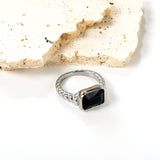 Oversized black diamonds on a threaded band ring.