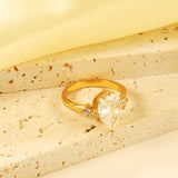 Set with a large teardrop diamond and two small diamond rings