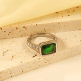 Oversized green diamonds on a threaded band ring.