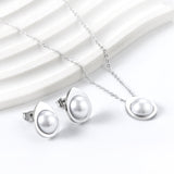 Teardrop shaped jewelry set with half white pearl steel color / gold