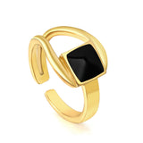 A minimalist ring with simple lines displayed with black drip polish