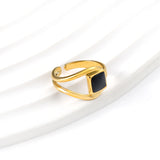 A minimalist ring with simple lines displayed with black drip polish