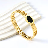 Woven mesh bracelet with black round oil drops.