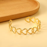 Bracelet with multiple openings in the shape of hollowed-out hearts linked together.