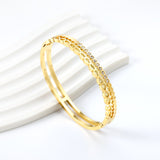 Gold-colored double stranded bracelet with diamonds