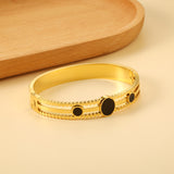 Chunky bracelet with three black oil-dripping circles