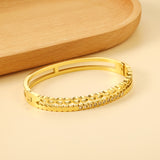 Gold-colored double stranded bracelet with diamonds