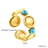 The ring consists of discs of various sizes and is set with 2 turquoise stones.