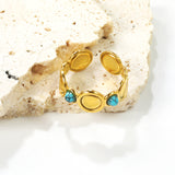 The ring consists of discs of various sizes and is set with 2 turquoise stones.