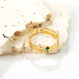 Open center ring with white and green diamonds.