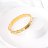 Hard bangle with blue scalloped dripping oils in a wide width