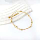 Bracelet de cheville double souple 6 petits accessoires carrés dorés 21 +5cm 