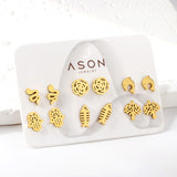 Six pairs of mixed card mounted cut-out fishbone / dolphin stud earrings gold color