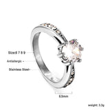 Solitaire ring with several small diamonds + one large round diamond Gold/steel color