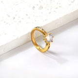 Solitaire ring with several small diamonds + one large round diamond Gold/steel color