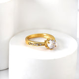 Solitaire ring with several small diamonds + one large round diamond Gold/steel color