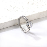 Solitaire ring with several small diamonds + one large round diamond Gold/steel color