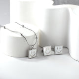 Square White Shell with Smiley Face Set Steel/Gold