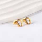 Gold U-shaped cut earrings with diamonds