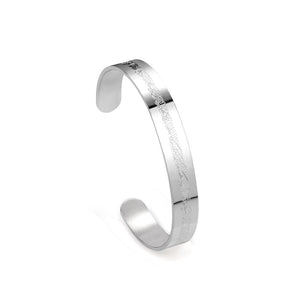 Extra wide hard open bangle in steel color with engraved surface