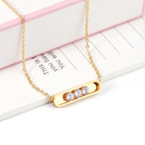 Golden hollow cylindrical center pendant necklace with white diamonds