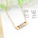 Golden hollow cylindrical center pendant necklace with white diamonds