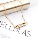 Golden hollow cylindrical center pendant necklace with white diamonds