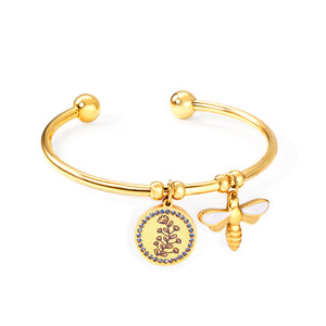 Hard bracelet with butterfly and flower charms