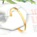 Gold colored hard bracelet with GODDESS printed on it