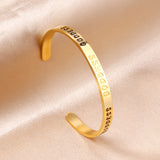 Gold colored hard bracelet with GODDESS printed on it